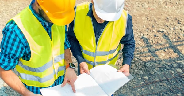 Construction project managers looking at a plan