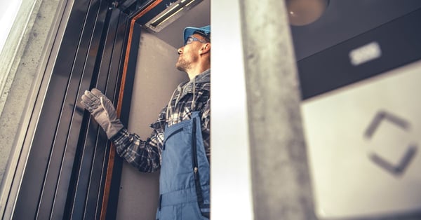 man checking for defaults on elevator door